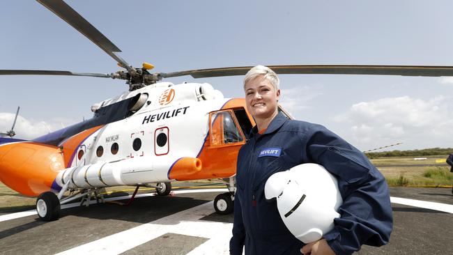 Captain Chantel van der Merwe stands by 'Mad Max', one of the largest aerial fighting helicopters in the world at Redcliffe Aerodrome in Brisbane. Picture: AAP