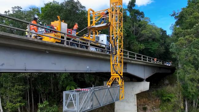 Roadtek employees work on the underside of the Barron River bridge at Kuranda. Picture: TMR