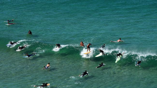 Surfers ride waves at Freshwater Beach following its closure on April 05, 2020. Pictre: Cameron Spencer/Getty Images.