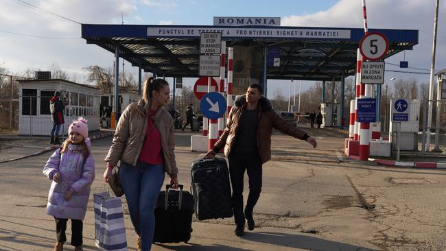 People enter Romania, after having crossed from Ukraine, on February 24