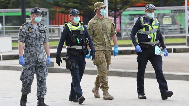 Police and ADF patrol Melbourne’s Docklands area. Picture: NCA NewsWire/ David Crosling