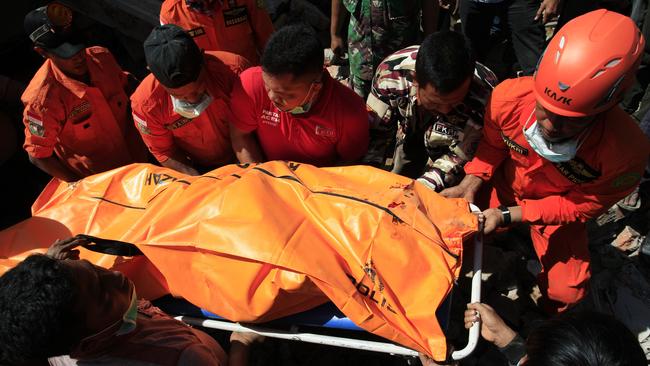 Rescue workers pull victims from destroyed buildings in Sigli, Aceh Province, Indonesia. An undersea earthquake struck Indonesia's northern Aceh province early on Wednesday. Many people are feared trapped under rubble. Picture: Getty