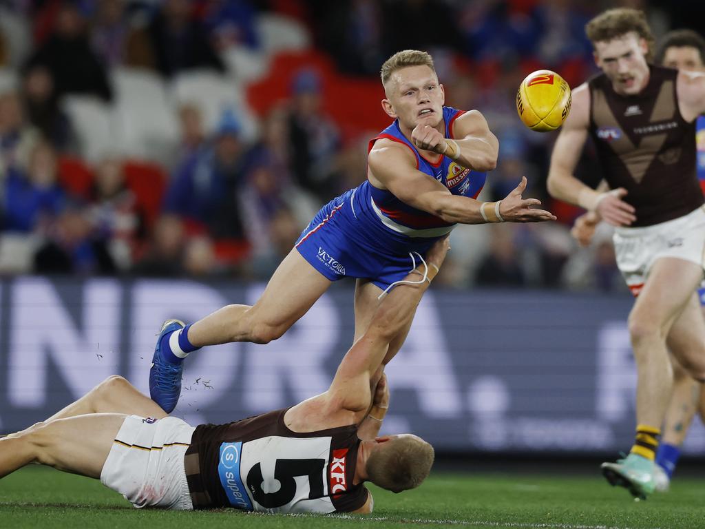 Adam Treloar fires out a handpass under pressure Picture: Michael Klein