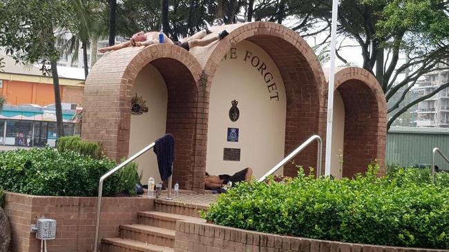 Men photographed sleeping in and on top of the Burleigh Heads War Memorial. Picture: Supplied