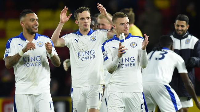 Leicester City's English defender Danny Simpson (L), Leicester City's Welsh midfielder Andy King (C) and Leicester City's English striker Jamie Vardy appluad the fans following the English Premier League football match between Watford and Leicester City at Vicarage Road Stadium in Watford, north of London on March 5, 2016. Leicester won the match 1-0. / AFP / OLLY GREENWOOD / RESTRICTED TO EDITORIAL USE. No use with unauthorized audio, video, data, fixture lists, club/league logos or 'live' services. Online in-match use limited to 75 images, no video emulation. No use in betting, games or single club/league/player publications. /