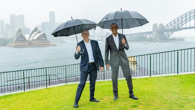 Weathering the storm ... Anthony Albanese meets Barack Obama in Sydney on Monday as the former US president begins a speaking tour. The leaders were snapped in the rain hours before the Prime Minister unveiled his deal with the Greens on climate change policy.