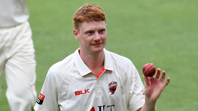 South Australian bowler Tom Andrews shows the ball as he leaves the field after taking 6 wickets on day 1 of the Round 9 Sheffield Shield cricket match between Queensland and South Australia at The Gabba. Picture:AAP/DAVE HUNT