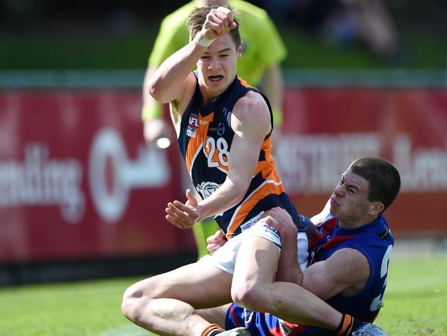 Jack Higgins lays a tackle on Ben Ronke in last year’s TAC Cup finals.