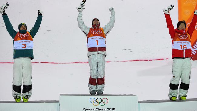 Matt Graham of Australia, Mikael Kingsbury of Canada and Daichi Hara of Japan stand on the podium after winning the silver, gold and bronze medals respectively in the men's moguls final. Photo: AAP