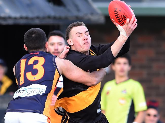 EDFL Football: Westmeadows v East Keilor at Westmeadows. Jordan Hollow under attack from Lindon Bektash. Picture: Steve Tanner