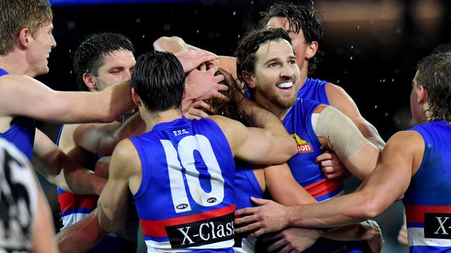 Western Bulldogs players flock to Roarke Smith after his first AFL goal. Picture: AAP Image/Sam Wundke.