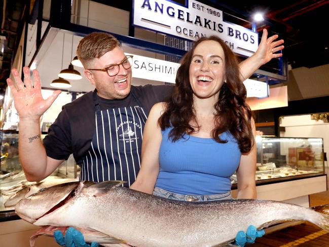 Seafood for this year's Easter table - Alex Knoll of Angelakis Seafoods, with customer, Lauren Brown, and a Kingfish. 8 April 2022. Picture Dean Martin