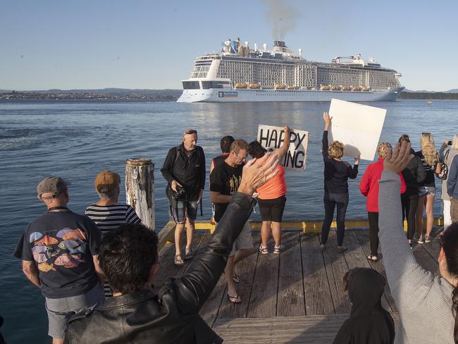 Locals gather to wave off the Ovation of the Seas cruise ship, which carried passengers who travelled to White Island when it erupted, in the Port of Tauranga. Picture: Getty