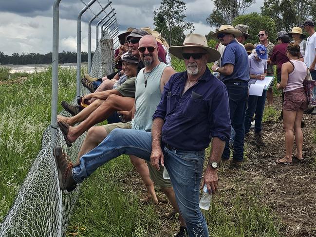 Protesters remove part of the new 1.8m high boundary fence on landowner Michelle Hunt's property at Bullyard, near Gin Gin in Queensland, after it was erected without her permission by the neighbouring solar farm. She says the original farm fence was ripped out and burned without her knowledge and she  wants the new security fence moved onto the solar farm's land, as per the development conditions. About 70 people came from throughout south-east Qld to help remove half of the fence