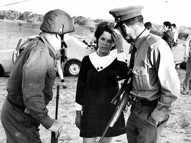 "Moments in Time" liftout and promotion.  Police talking to hostage Monica Schiller after she was kidnapped by three prison escapees who were captured on the Birdsville Track after escaping from Cadell Training Centre 14 Sep 2006. escape crime escape 1970s Picture: Supplied