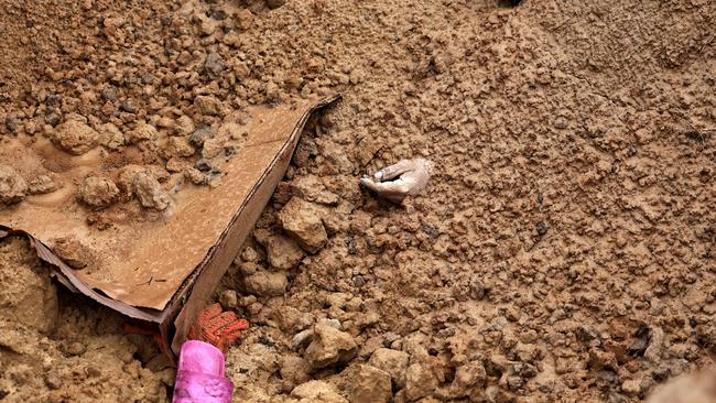 A grisly marker of one of a number of mass graves containing some 280 people in Bucha on Saturday. Picture: Reuters