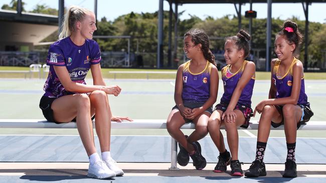 The Queensland Firebirds have held a player clinic for junior netballers at Cairns Netball following their victory over the Melbourne Vixens in Cairns on Sunday. Queensland Firebird player Rudi Ellis shares a laugh with Phoenix Fierce players and cousins Marutta Gulplil, 9, Nahla Moke, 8, and Mya Moke, 11. PICTURE: BRENDAN RADKE