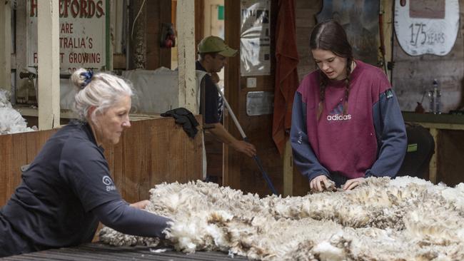 Bridgit Burns from Vancouver, Canada, learning the finer details of skirting from wool handling from teacher Marion Kelly. Picture: Zoe Phillips