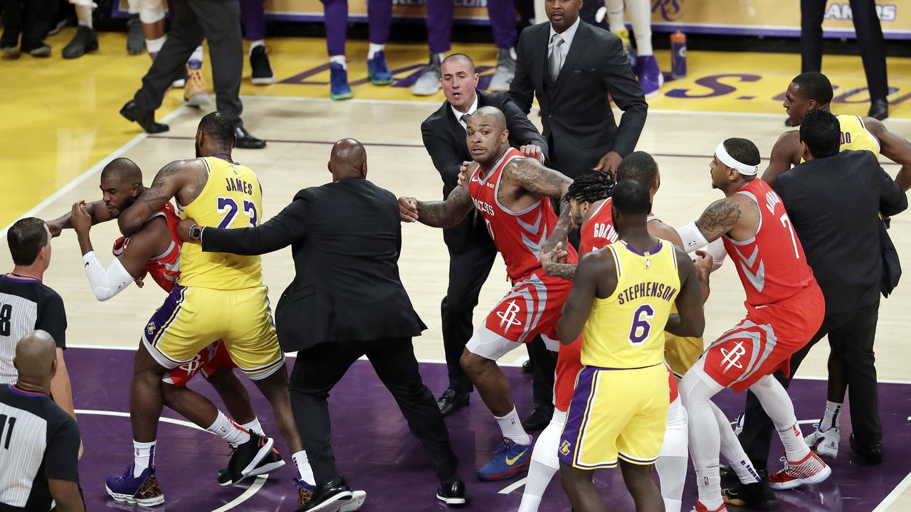 Houston Rockets' Chris Paul, far left, is held back by Los Angeles Lakers' LeBron James, second from left, after Paul fought with Lakers' Rajon Rondo.