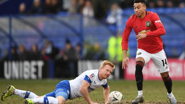 Manchester United’s Jesse Lingard makes light work of David Perkins of Tranmere Rovers.