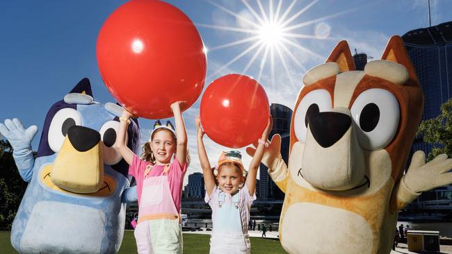 Sister Jasmine 7, and Lilah Johnstone 5, with Bluey and Bingo after taking part in the Bluey world record attempt for the biggest game of Keep Uppy at Southbank on Sunday morning. Picture Lachie Millard