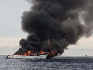 Eight rescued after boat erupts in flames off Coast