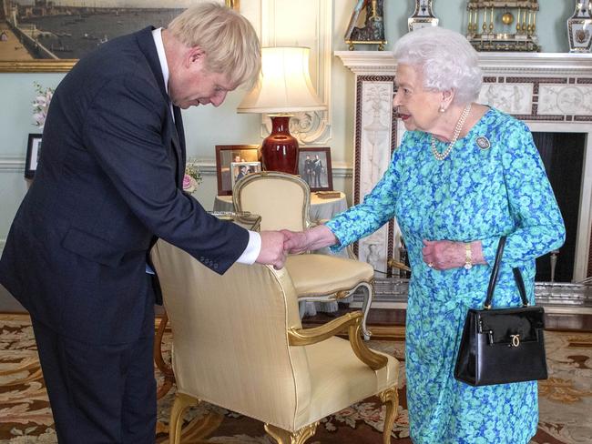 LONDON, ENGLAND - JULY 24: Queen Elizabeth II welcomes newly elected leader of the Conservative party, Boris Johnson during an audience where she invited him to become Prime Minister and form a new government in Buckingham Palace on July 24, 2019 in London, England. The British monarch remains politically neutral and the incoming Prime Minister visits the Palace to satisfy the Queen that they can form her government by being able to command a majority, holding the greater number of seats, in Parliament. Then the Court Circular records that a new Prime Minister has been appointed.  (Photo by Victoria Jones - WPA Pool/Getty Images)