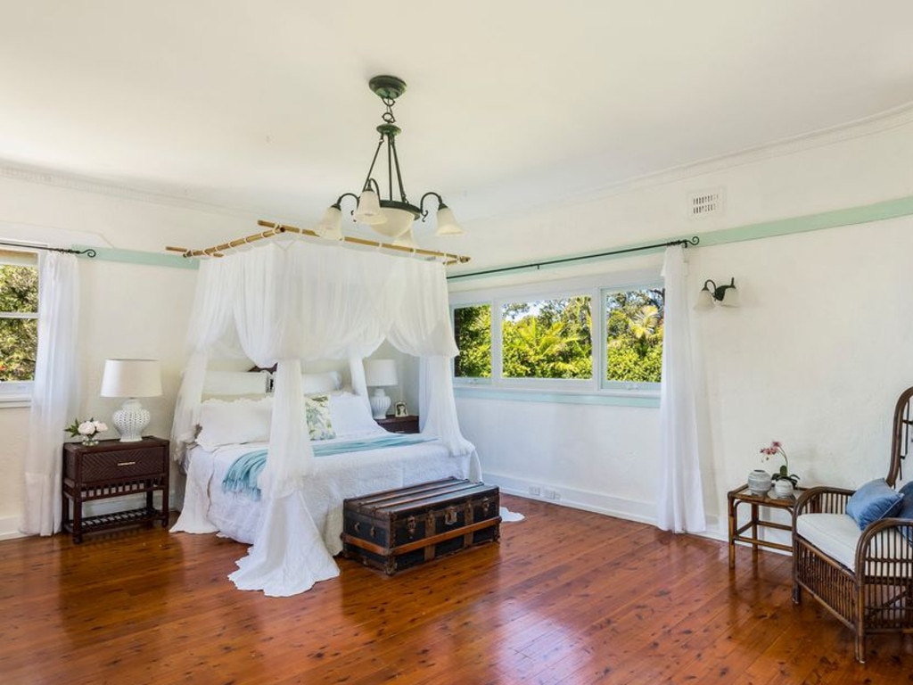 The main bedroom with its high ceiling, hardwood floor and large proportions.
