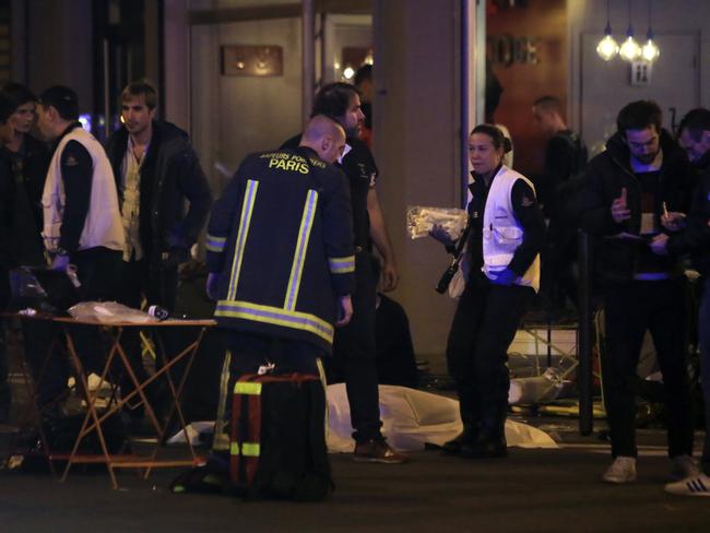 Deadly night ... Rescue workers and medics work on victims in a Paris restaurant.