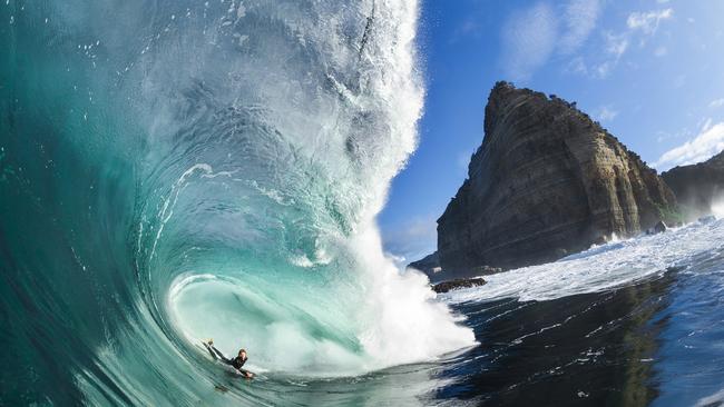 Surfer Harley Ward taking the perfect line through a beautiful Shipstern Bluff wave, with the bluff in full view. The image features in a new book by surfer Marti Paradisis. Picture: Mat Tildesley