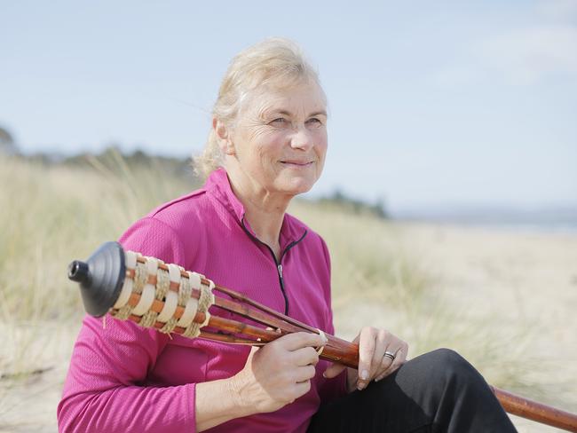 Shane Gould with her unsnuffed torch from <i>Australian Survivor</i> on the beach at Bicheno, where she and her husband spend half the year. Picture: MATHEW FARRELL