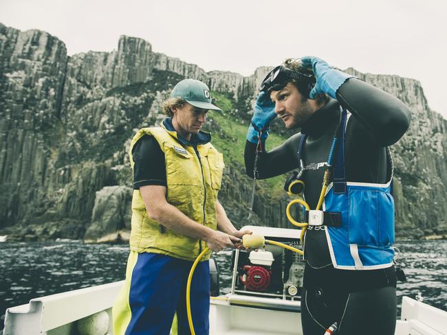 Abalone diver James Polanowski is helped by trusted deckhand Andrew Chisholm. Picture: STUART GIBSON