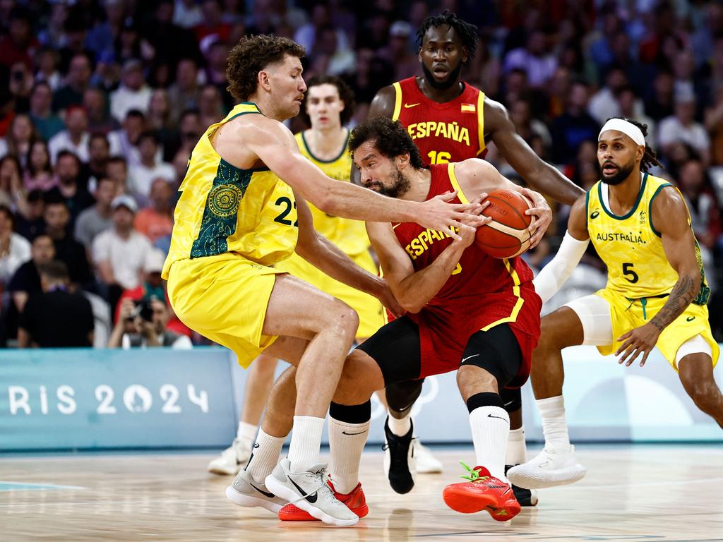 Spain's Sergio Llull handles the ball past Australia's Will Magnay. Picture: AFP