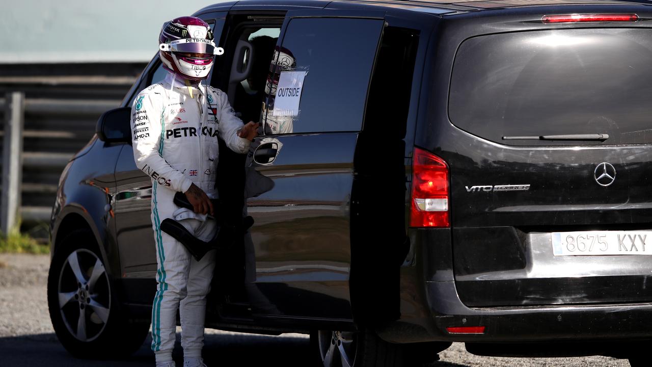 Lewis Hamilton gets into a recovery vehicle after his car stopped on track in Barcelona.