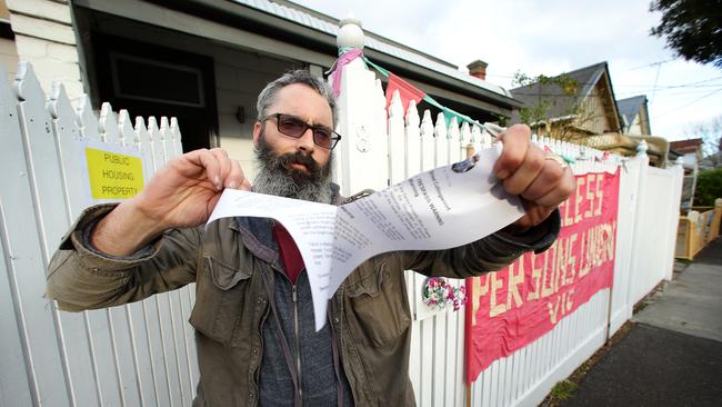 Homeless delegate Joel Bynon tears up an eviction notice. Picture Norm Oorloff