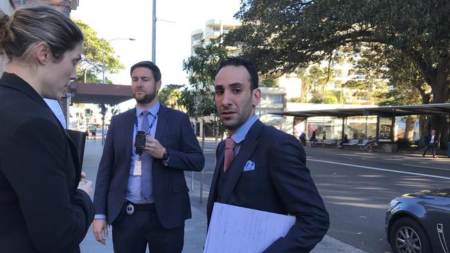 Eidan Havas (right) being arrested by police outside Manly Court.