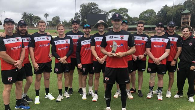 Rob Aitken surrounded by teammates ahead of his 500th match.