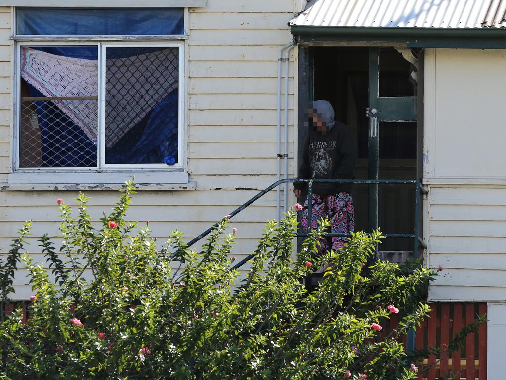 A woman leaves a squat house at Southport. Photo: Glenn Hampson