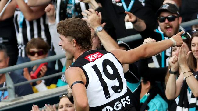 Mitch Georgiades celebrates one of his four goals with Port Adelaide’s fans.