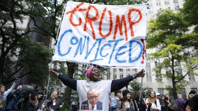 TOPSHOT - People react after former US President and Republican presidential candidate Donald Trump was convicted in his criminal trial outside of Manhattan Criminal Court in New York City, on May 30, 2024. A New York jury convicted Donald Trump on all charges in his hush money case on May 30, 2024 in a seismic development barely five months ahead of the election where he seeks to recapture the White House. (Photo by Kena Betancur / AFP)