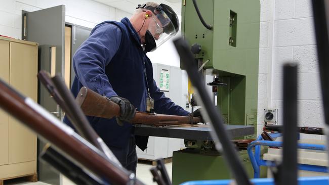 An officer cuts a rifle in two after last year’s amnesty. Picture: NSW Police Media