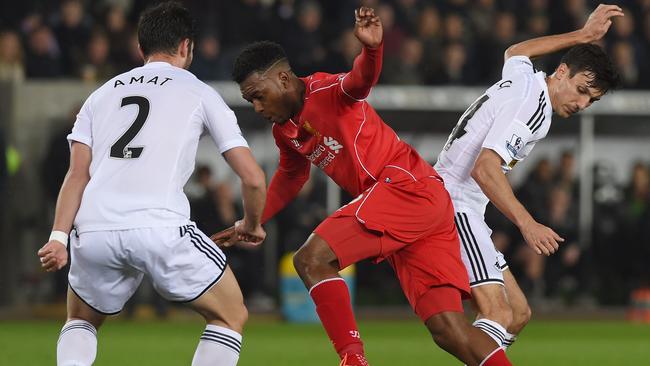 Liverpool's English striker Daniel Sturridge (C) vies for the ball.