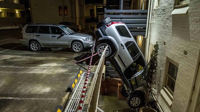 The four-wheel-drive was wedged between floors after crashing through a barrier. Picture: Jake Nowakowski