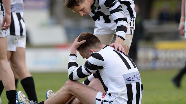 Narre Warren number 11 Ryan Quirk is consoled after the siren. Picture: Chris Eastman