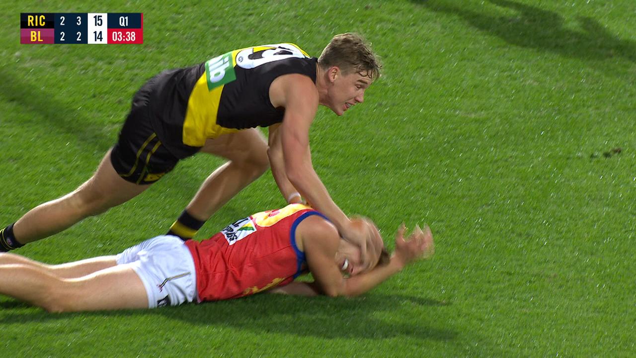 Richmond's Tom Lynch drives down the head of Brisbane's Alex Witherden.