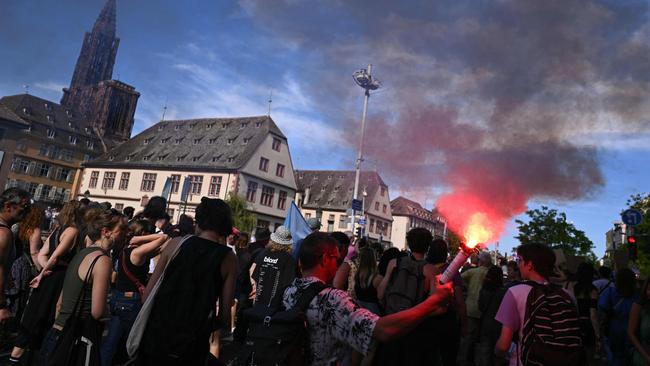 A protester in Strasbourge hold a smoke flare during a demonstration on Saturday. Picture: AFP