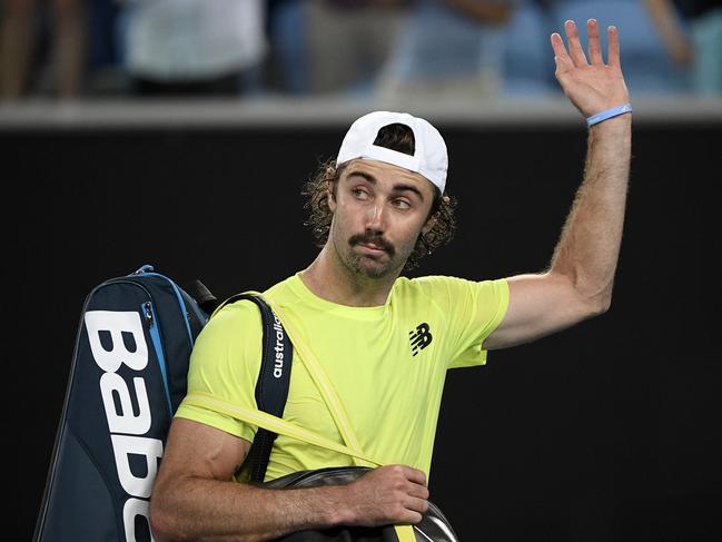 Australia's Jordan Thompson waves as he leave the court after losing his second round match to Italy's Fabio Fognini at the Australian Open tennis championship in Melbourne, Australia, Thursday, Jan. 23, 2020. (AP Photo/Andy Brownbill)