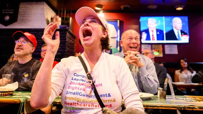Patrons react during a watch party for the first presidential debate of the 2024 presidential elections between US President Joe Biden and former US President and Republican presidential candidate Donald Trump at a pub in San Francisco, California, on June 27, 2024. (Photo by JOSH EDELSON / AFP)