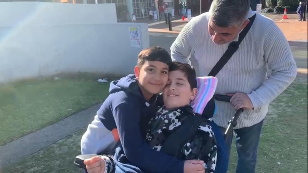 Jerome (in a wheelchair) with brother Levi and father Steve Kertebani. Picture: Supplied