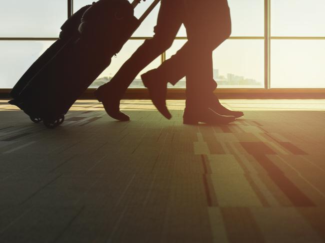 ESCAPE: Travel story on Frequent Flyer credits and airline loyalty point programs. By Lisa Mayoh. iStockSilhouette traveller with luggage walking in the airport